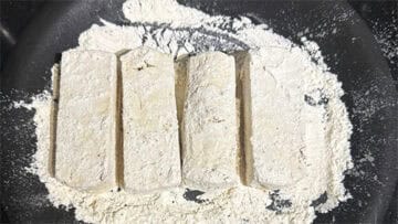 Tofu dredged in flour.