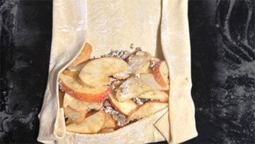 Apple filling placed on puff pastry.