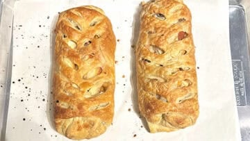 Baked vegan apple strudel logs on baking sheet.