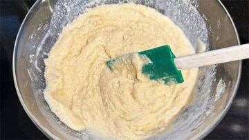 Fig and almond cake batter mixed in bowl.