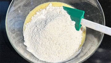Dry ingredients added to wet ingredients in bowl.