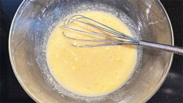 Wet ingredients whisked in bowl.