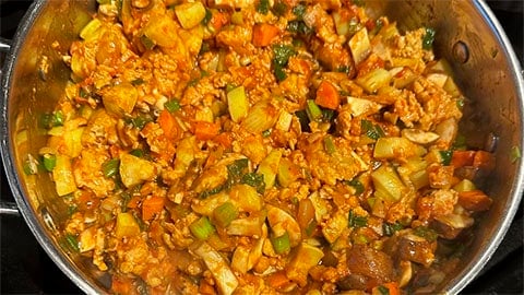 Vegan sausage added to pot.