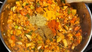 Powdered spices added to pot.
