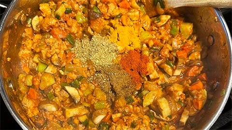 Powdered spices added to pot.