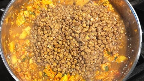 Lentils added to veggies and spices.