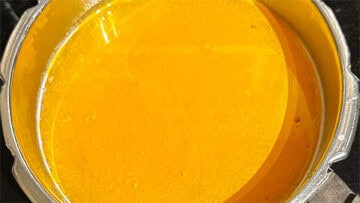 Lentils in saucepan with turmeric.