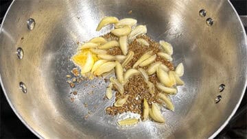 Garlic, cumin and asafetida in pan.