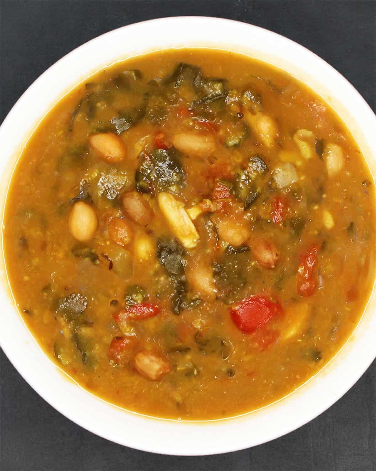Top down view of moringa dal in white bowl.