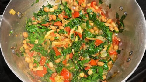 Moringa leaves in pan after they have cooked down for a couple of minutes.