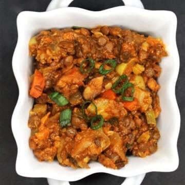 Lentil curry in square bowl.