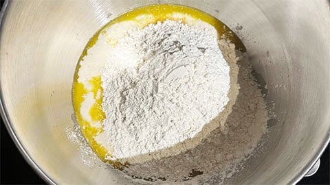 Flour, milk, butter and sourdough starter in bowl.