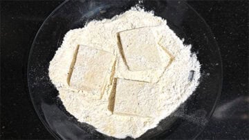 Tofu dredged in cheese and flour mixture.