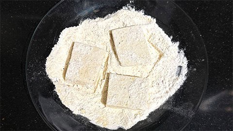 Tofu dredged in cheese and flour mixture.