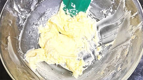 Vegan butter and sugar creamed together in bowl.