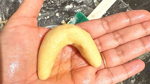 Curved Viennese crescent on hand.