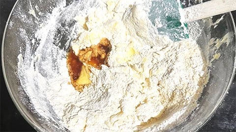 Flours and vanilla added to creamed butter and sugar.