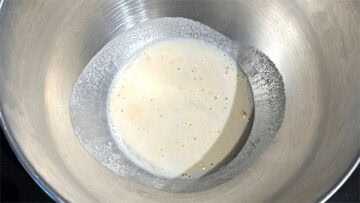 Yeast, sugar and water mixed in bowl.