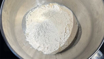 Flour and vital wheat gluten added to yeast mixture.