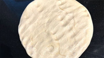 Dough punched into a circle.
