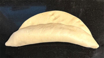 Whole wheat baguette dough being rolled.