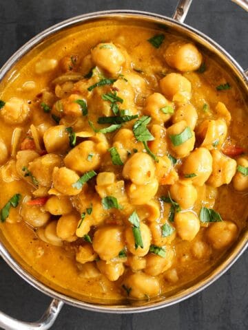 Chickpea curry in an Indian-style steel karahi bowl.