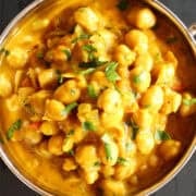 Top down view of chickpea curry in an Indian karahi bowl.