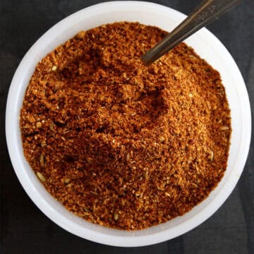 Homemade chili powder in bowl with spoon.