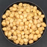 Perfectly cooked chickpeas in black bowl.