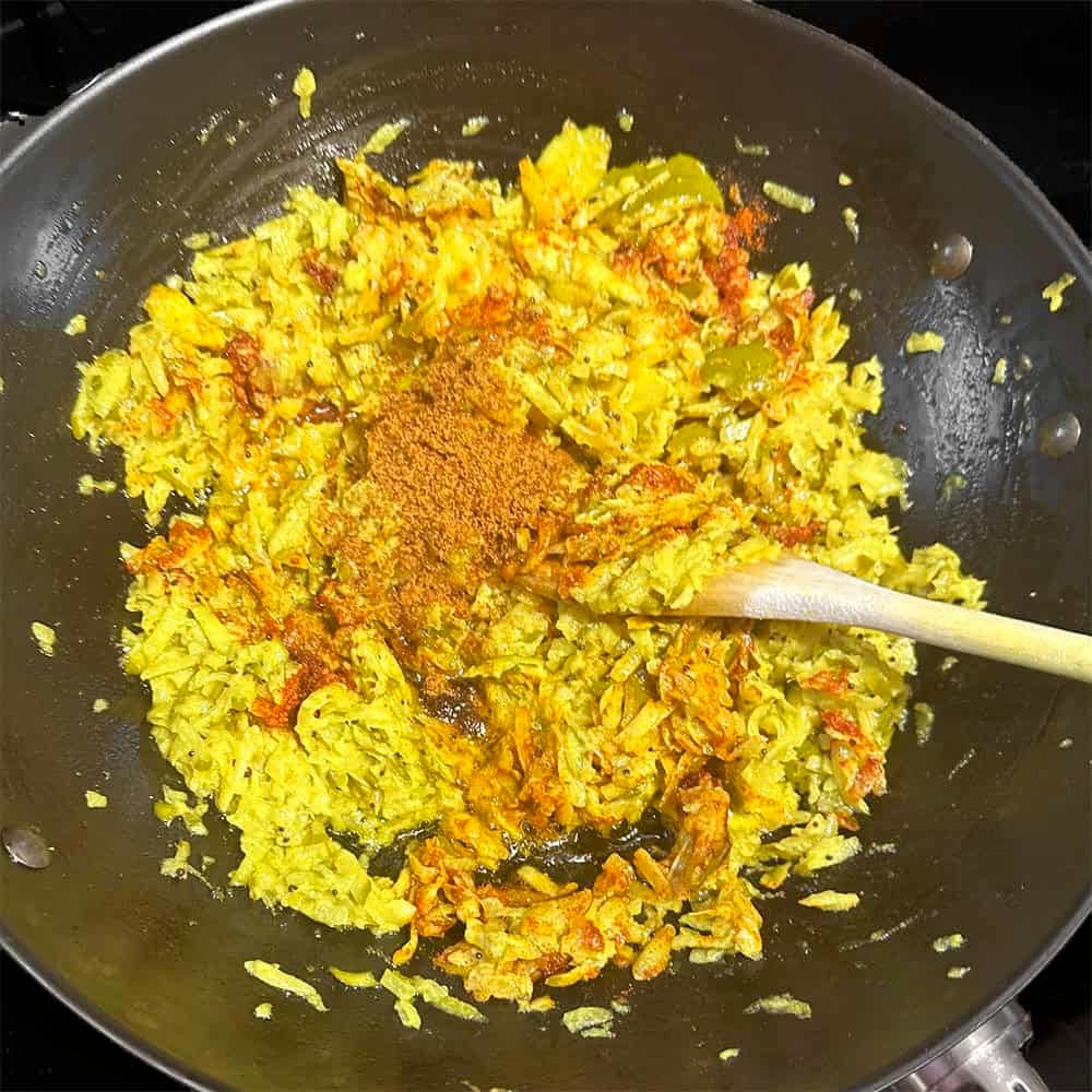 Red chili powder and jaggery added to mangoes.