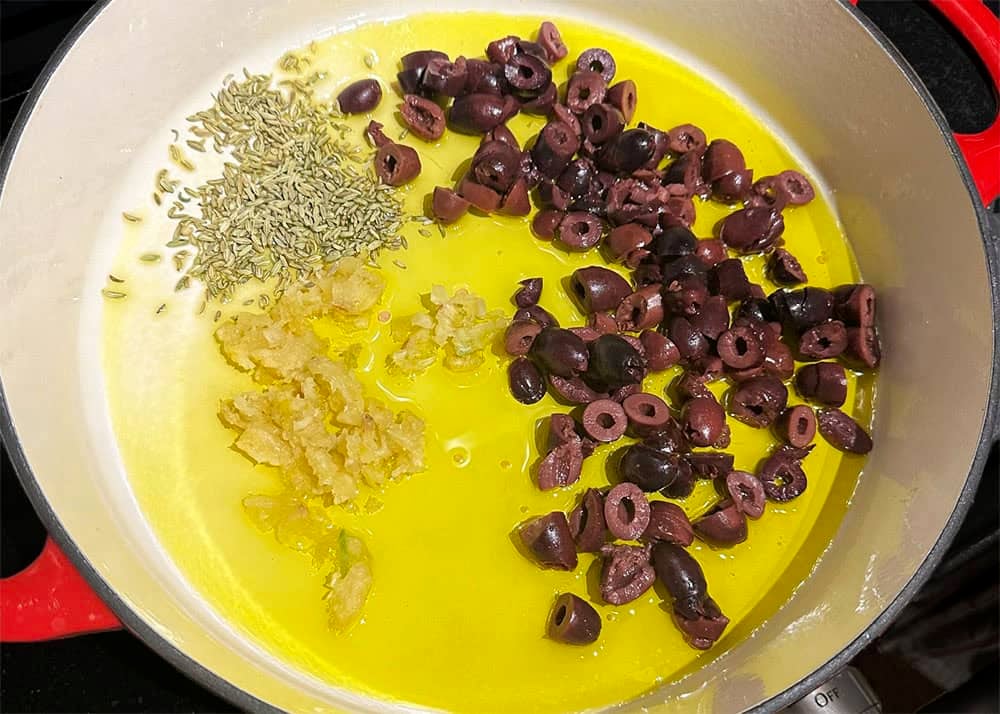 Garlic, olives and fennel seeds sauteing in olive oil.