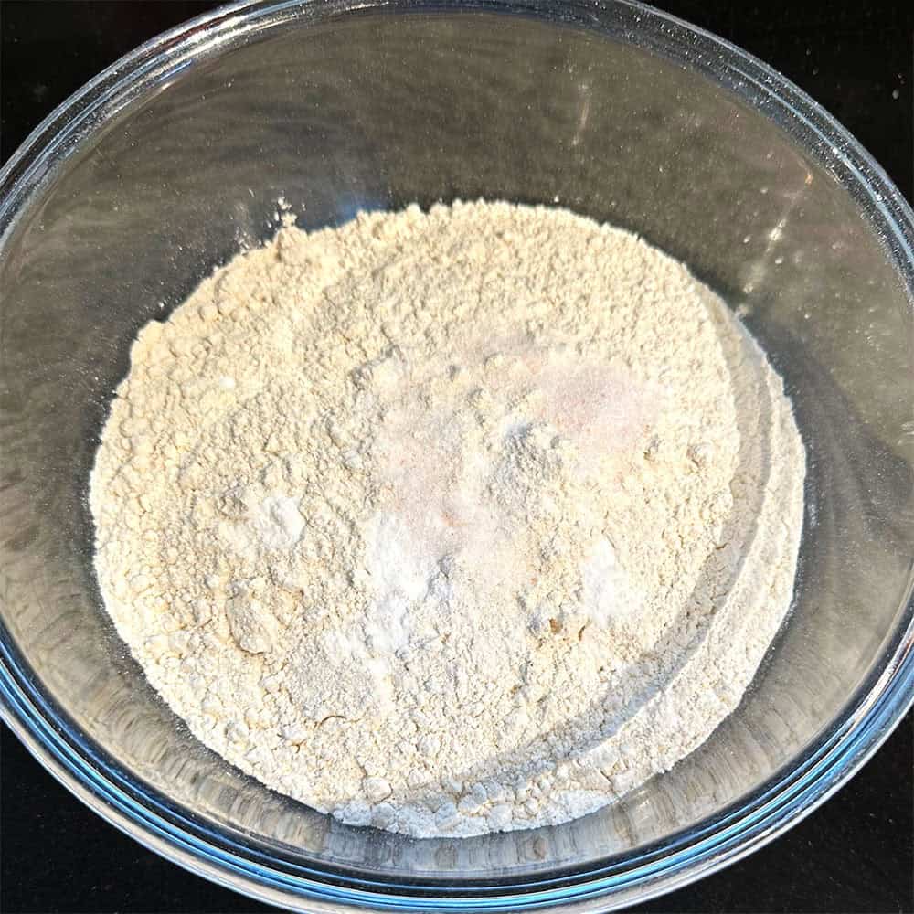 Flours, baking soda and salt in bowl.
