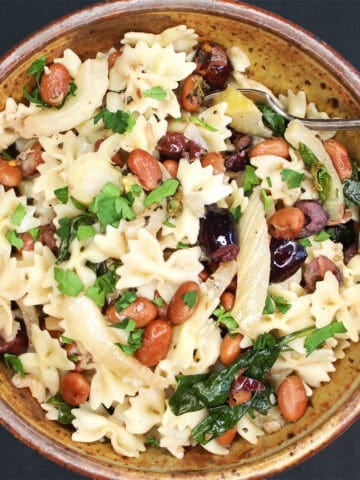 Top down view of a bowl of pasta with fennel and beans.