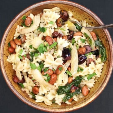 Top down view of pinto beans and fennel pasta in bowl.