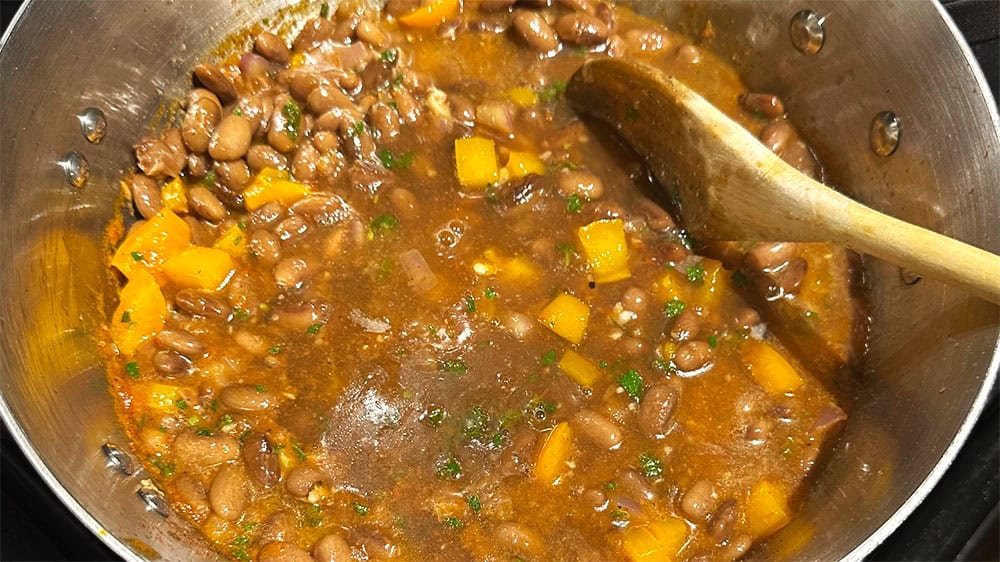 Beans and vegetable stock added to pot.
