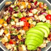 Kidney beans salad in bowl with sliced avocado and spoon.