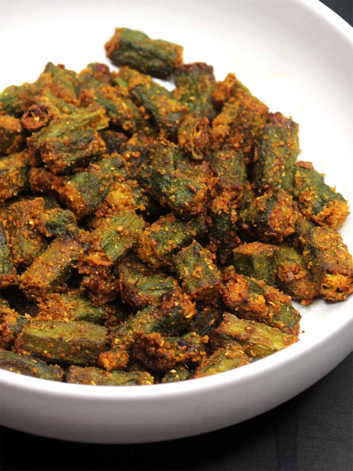 Close-up shot of crispy air fryer okra in bowl.