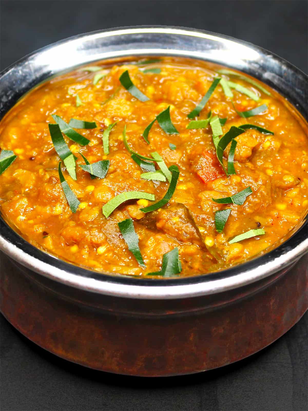 Instant Pot sambar in a dekchi-style serving bowl.